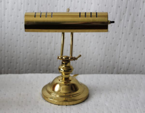 Antique brass desk lamp offers a dignified friendly look in the parlor