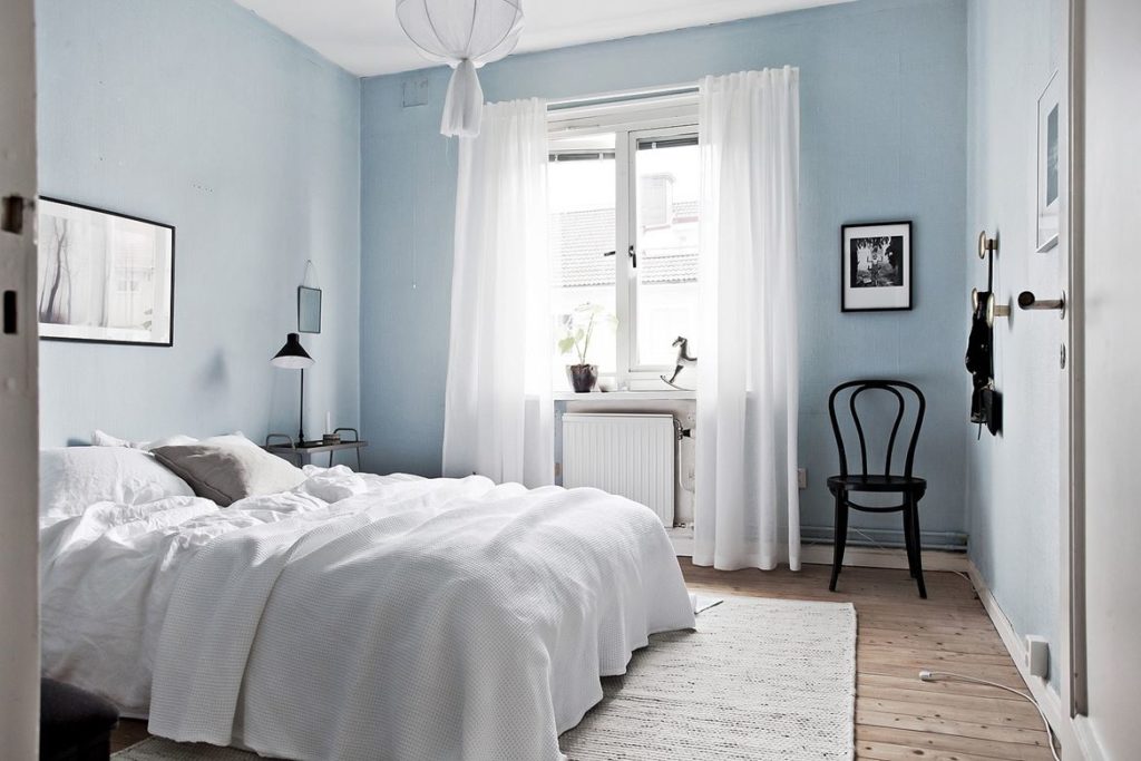 light blue bedroom walls with dark furniture