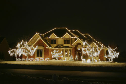 Night Christmas House 2. House is outlines and trees and yard decor lights included. Along the lower edge is a faint outline of a snow bank along the road.