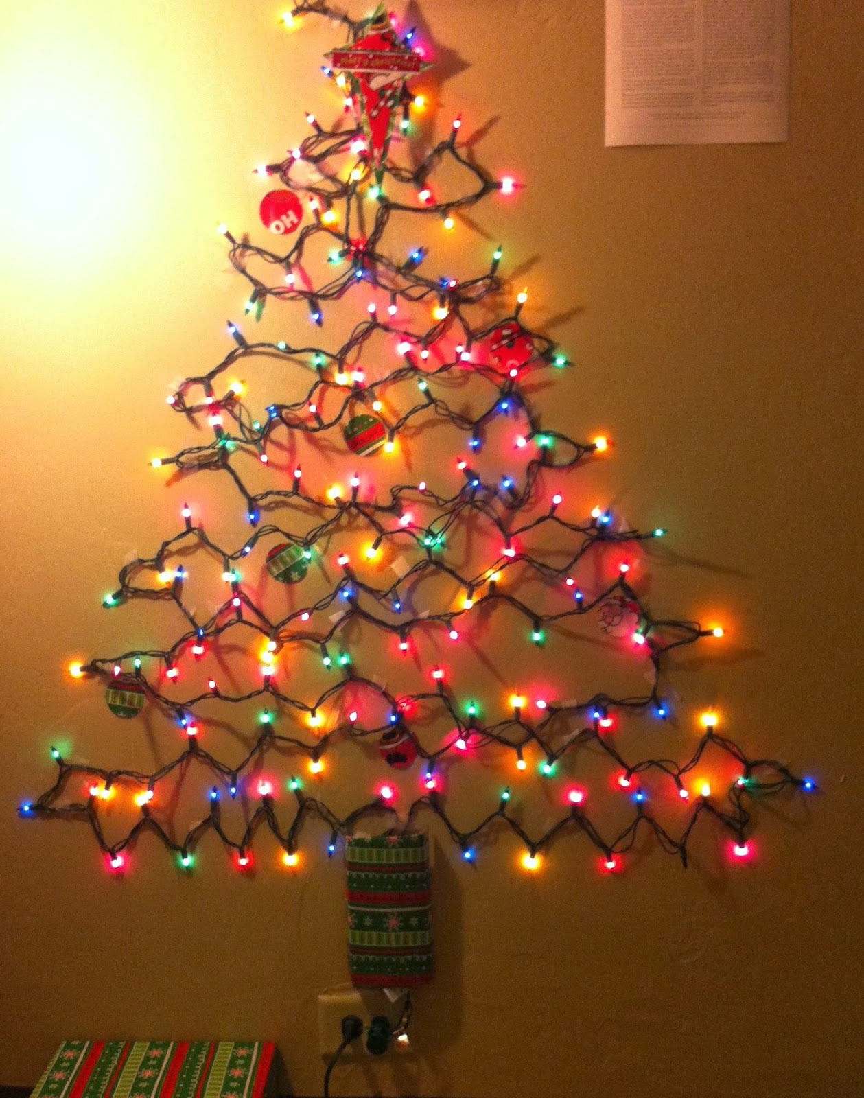 christmas tree made of lights on wall photo - 1